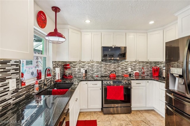 kitchen featuring stainless steel appliances, white cabinets, a sink, and tasteful backsplash