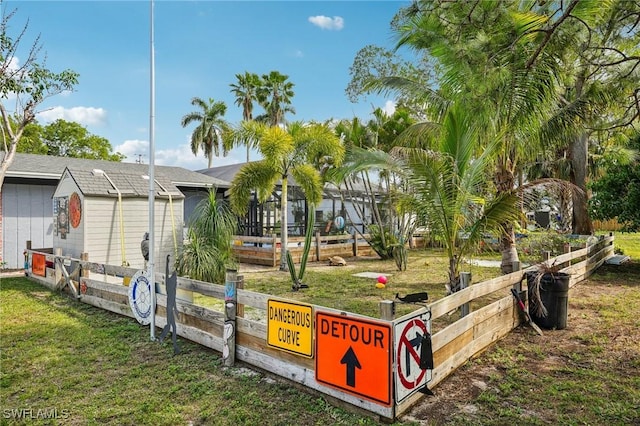 view of property's community with a yard and fence