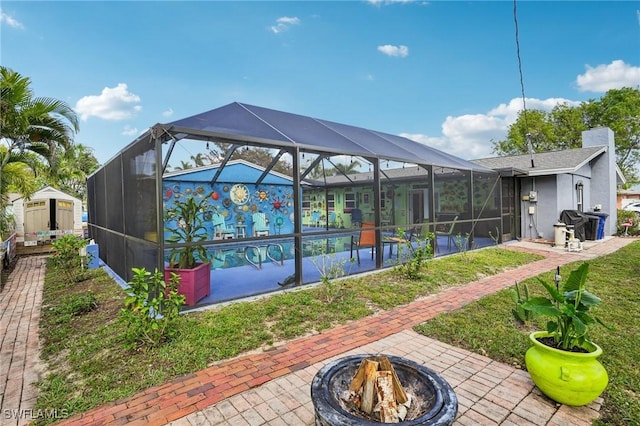 exterior space featuring a patio area, an outdoor fire pit, and a pool