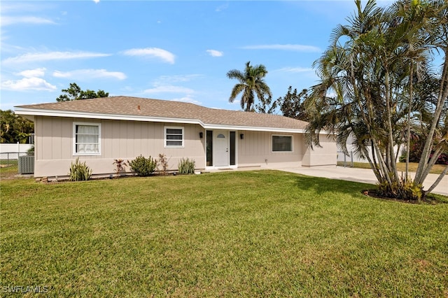 ranch-style home featuring a front yard, fence, and central air condition unit