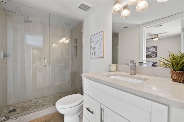 full bath with toilet, a shower stall, and visible vents