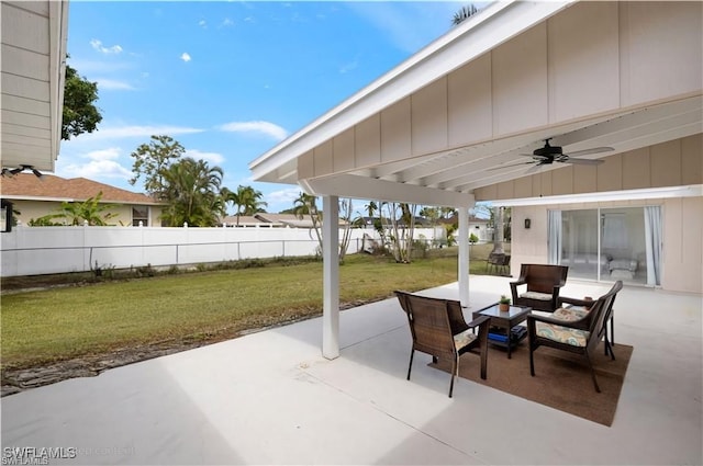 view of patio featuring ceiling fan and fence