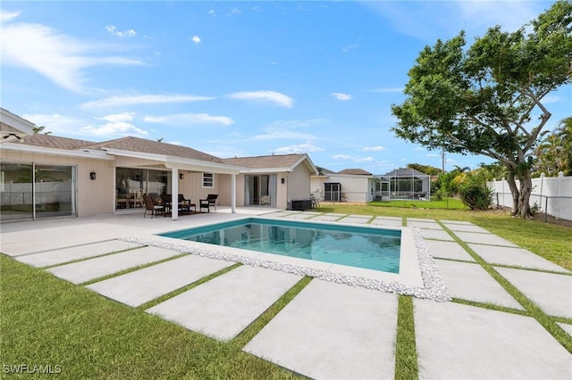 view of pool featuring a patio, a lawn, fence, and a fenced in pool