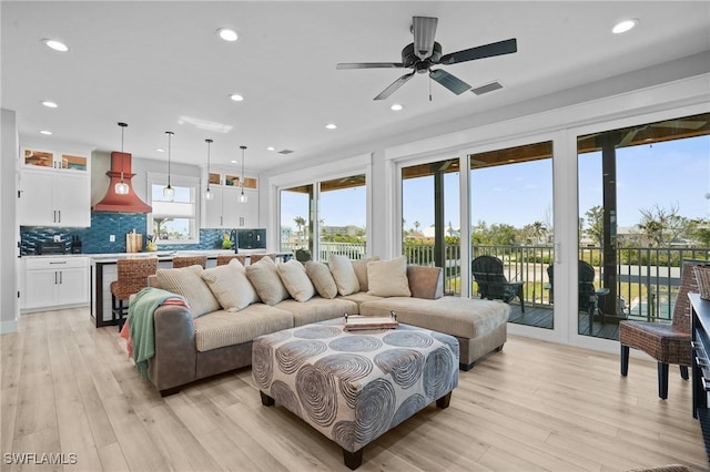 living room featuring recessed lighting, light wood finished floors, and ceiling fan