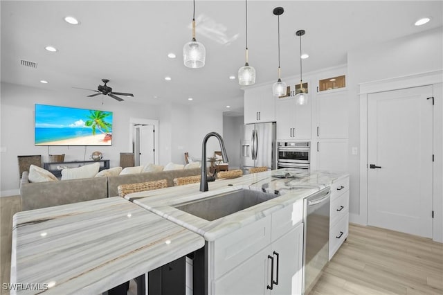 kitchen with a sink, visible vents, appliances with stainless steel finishes, and recessed lighting