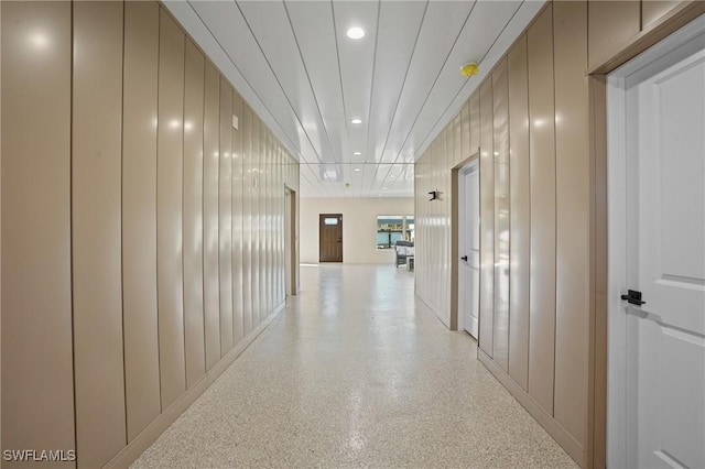 hallway featuring recessed lighting and light speckled floor