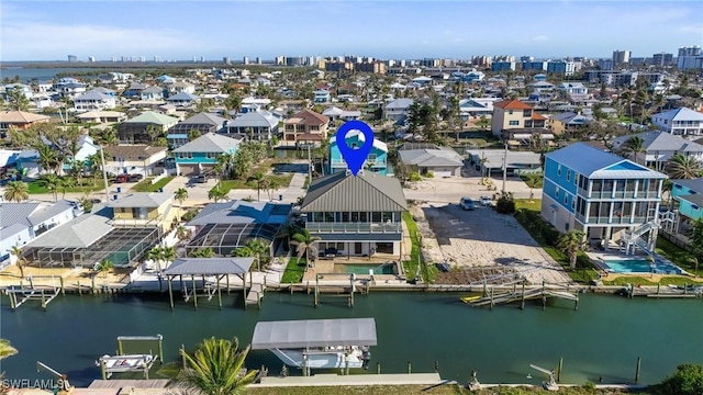 drone / aerial view with a water view and a residential view