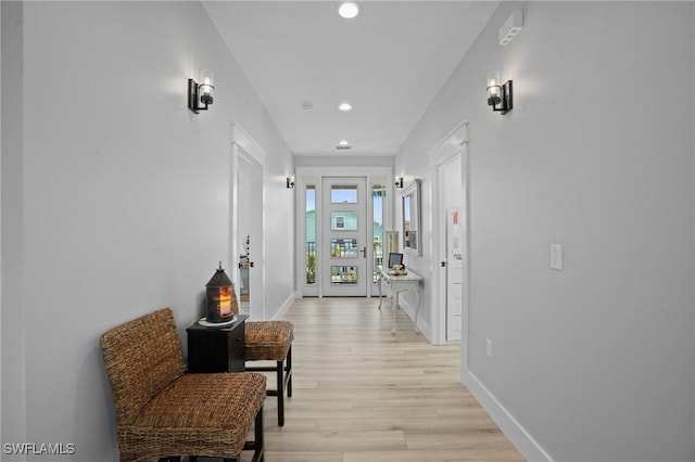 hall featuring light wood finished floors, recessed lighting, and baseboards