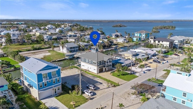 birds eye view of property with a residential view and a water view