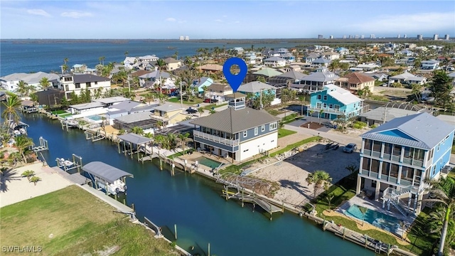 birds eye view of property with a residential view and a water view