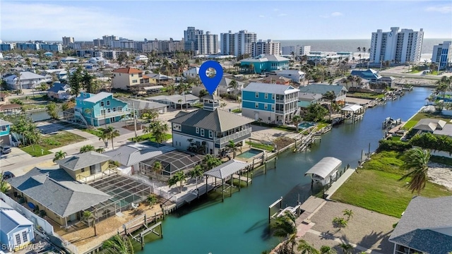 drone / aerial view featuring a view of city and a water view