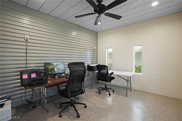 office area with recessed lighting, speckled floor, ceiling fan, and a textured wall