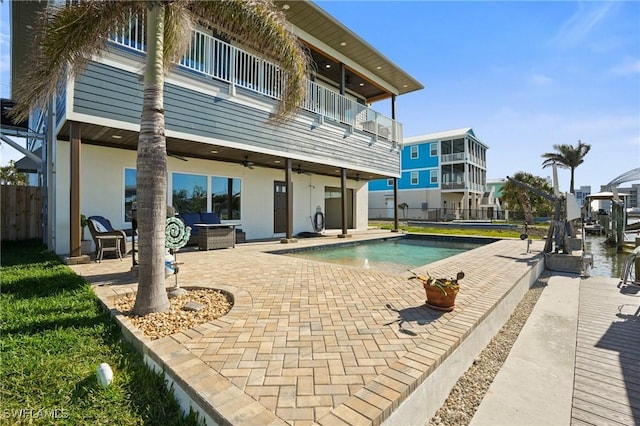 view of swimming pool with a patio area, a fenced in pool, a ceiling fan, and fence