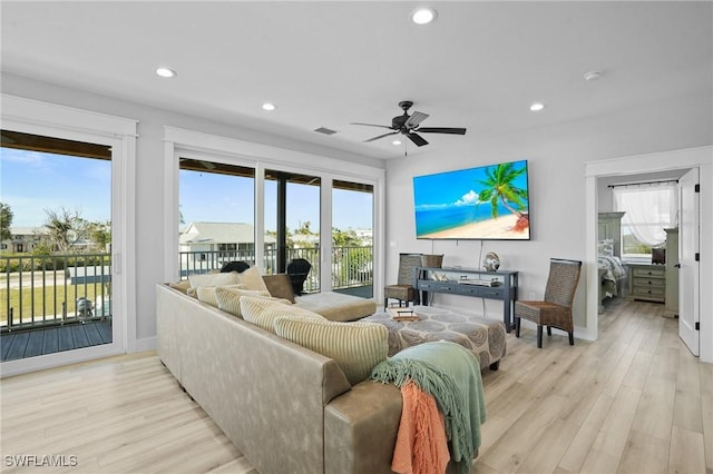 living room with light wood-style flooring, recessed lighting, and visible vents