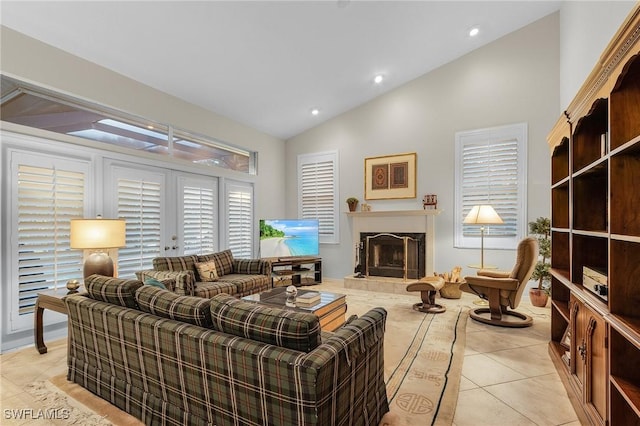 living room with vaulted ceiling, light tile patterned floors, a tile fireplace, and recessed lighting