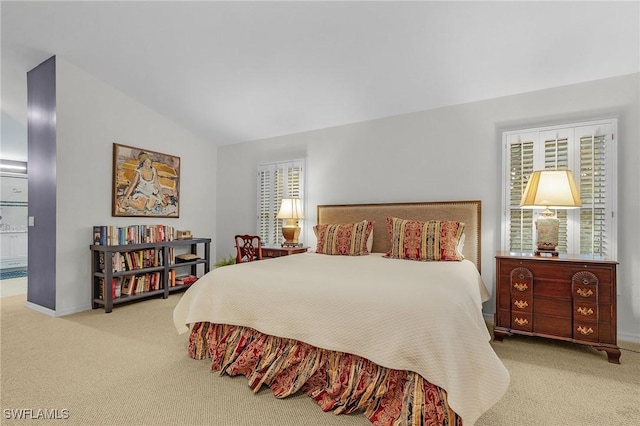 bedroom featuring carpet, baseboards, and vaulted ceiling