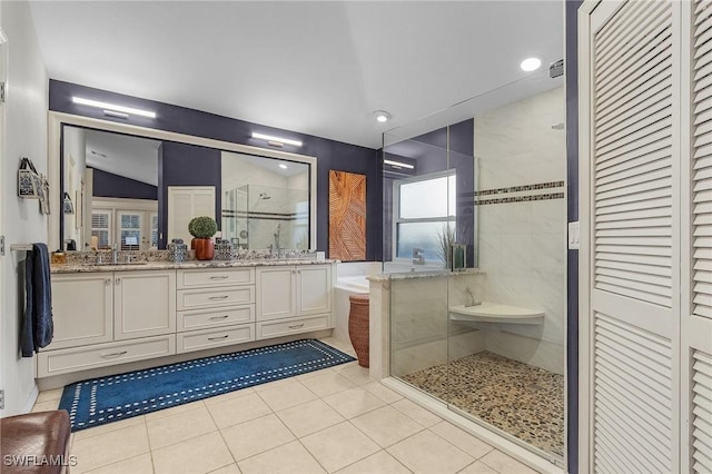 full bath with a sink, tile patterned flooring, a shower stall, and a bath