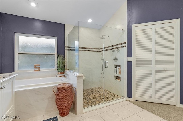 full bath featuring a stall shower, a closet, and a garden tub