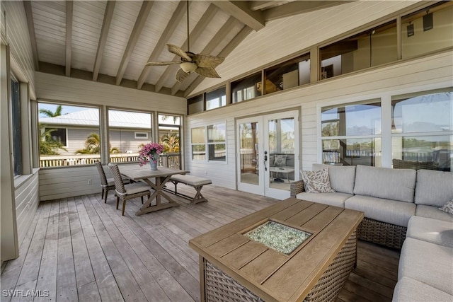 sunroom with lofted ceiling with beams, ceiling fan, a wealth of natural light, and french doors