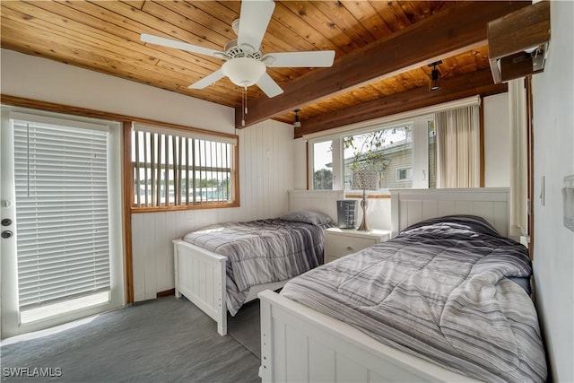 carpeted bedroom featuring ceiling fan, wooden ceiling, and beam ceiling