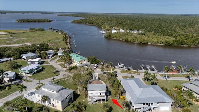 drone / aerial view featuring a water view and a forest view