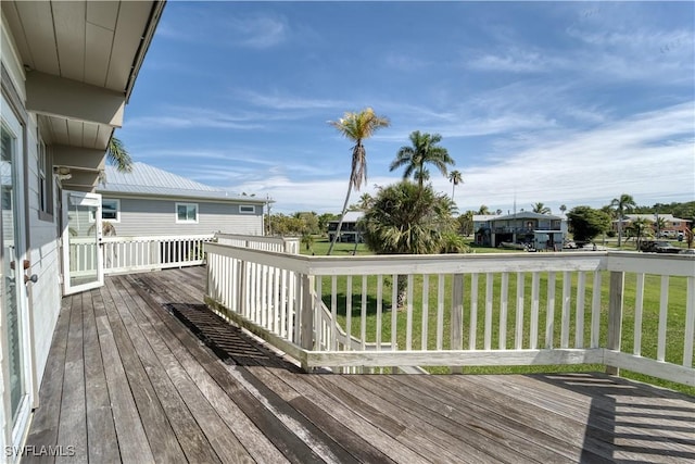 wooden deck featuring a lawn