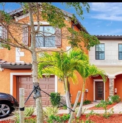 view of front of home featuring an attached garage and stucco siding