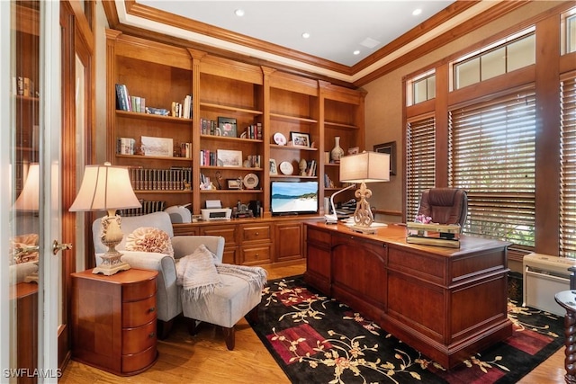 office space with light wood-type flooring and crown molding