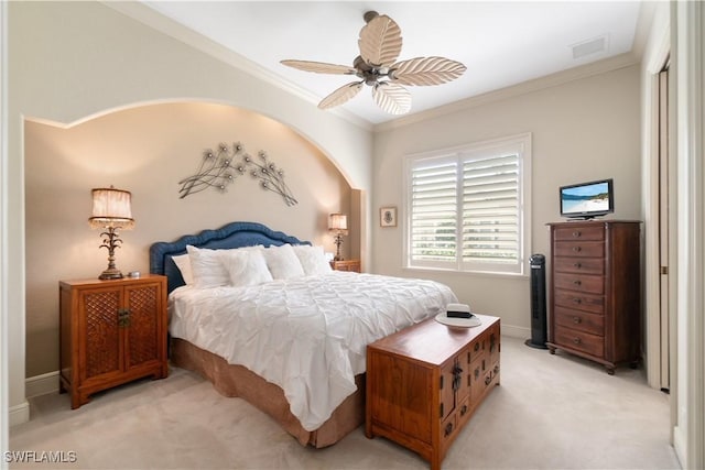 bedroom with crown molding, visible vents, light carpet, ceiling fan, and baseboards