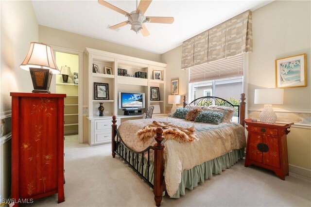 bedroom with a ceiling fan and light colored carpet