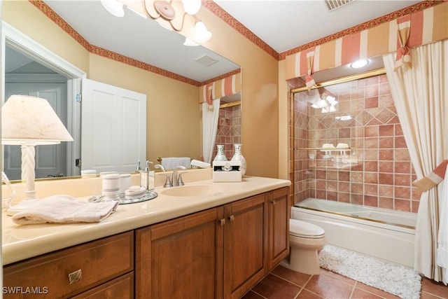 full bathroom featuring visible vents, bath / shower combo with glass door, toilet, tile patterned flooring, and vanity