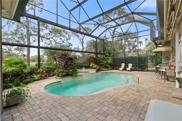 view of pool with glass enclosure, a pool with connected hot tub, outdoor dining space, and a patio