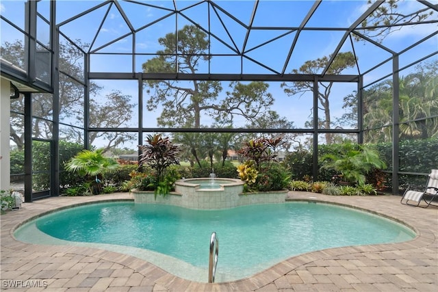 view of pool with a patio area, a lanai, and a pool with connected hot tub