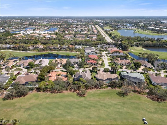 drone / aerial view with a water view, a residential view, and golf course view