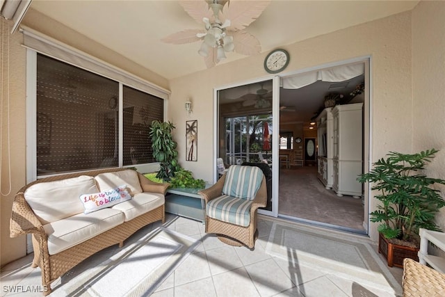 sunroom / solarium featuring ceiling fan