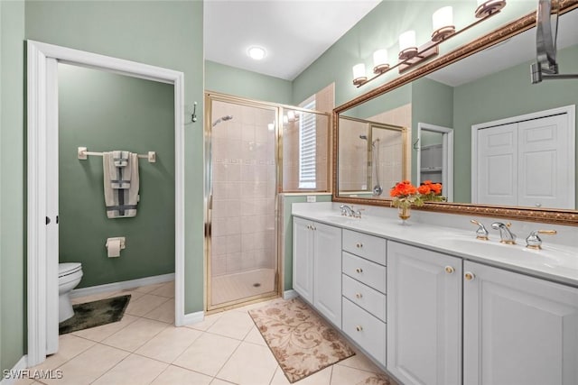 full bath with double vanity, a stall shower, a sink, and tile patterned floors