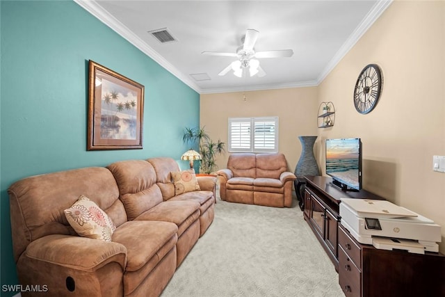 living room featuring ceiling fan, visible vents, crown molding, and light colored carpet