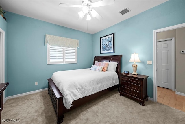 carpeted bedroom with visible vents, ceiling fan, and baseboards