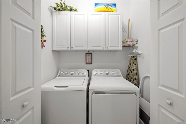 washroom with separate washer and dryer and cabinet space