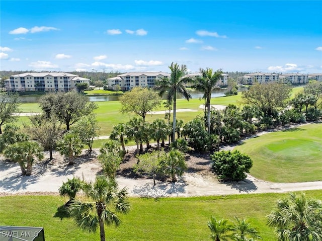 view of home's community featuring a lawn and a water view