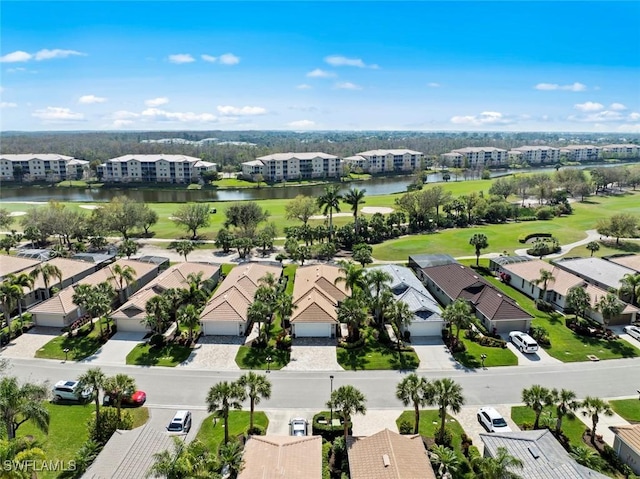 bird's eye view featuring golf course view, a water view, and a residential view