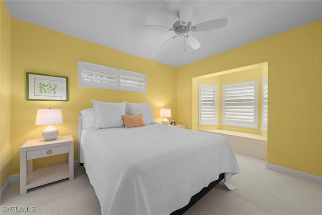 bedroom featuring ceiling fan, baseboards, and carpet floors