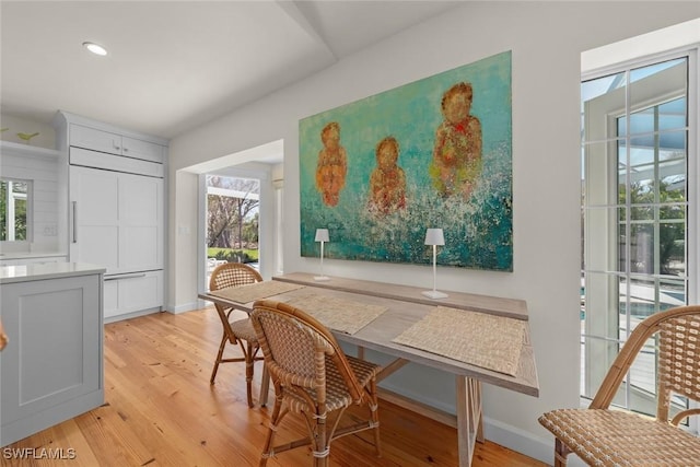 dining space featuring light wood finished floors, recessed lighting, and baseboards