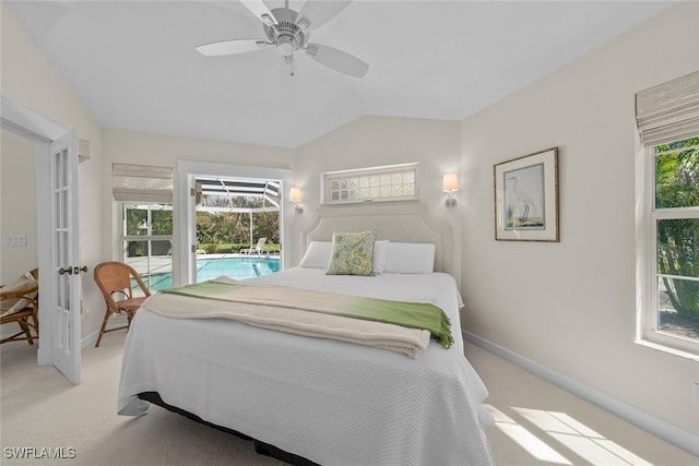 bedroom with baseboards, lofted ceiling, and light colored carpet