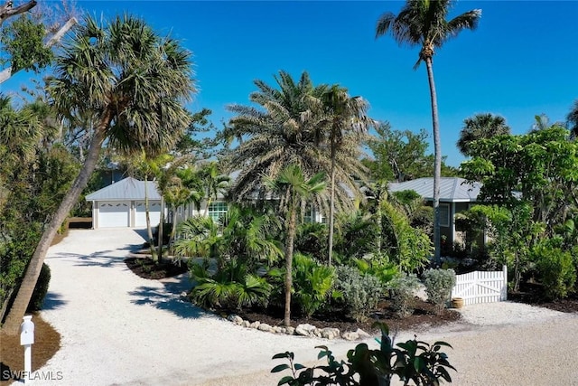 view of front of house featuring a gate, fence, and driveway