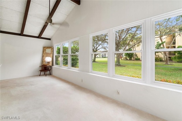 unfurnished sunroom with lofted ceiling with beams