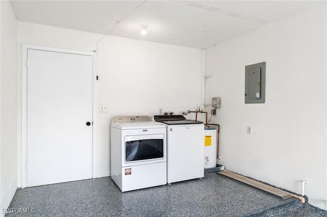 laundry room with a textured ceiling, gas water heater, washing machine and dryer, laundry area, and electric panel