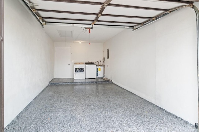 garage featuring electric panel, electric water heater, and washing machine and clothes dryer