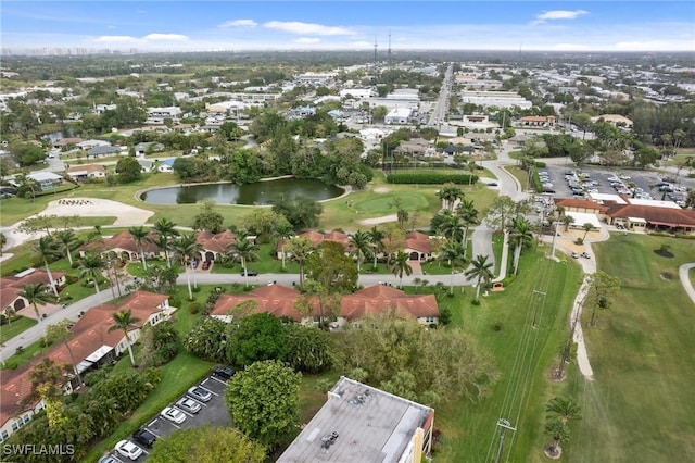 bird's eye view with golf course view, a water view, and a residential view