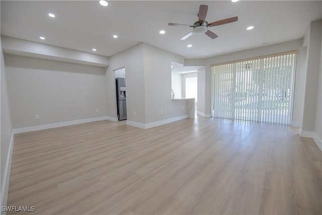 empty room featuring recessed lighting, baseboards, ceiling fan, and light wood finished floors